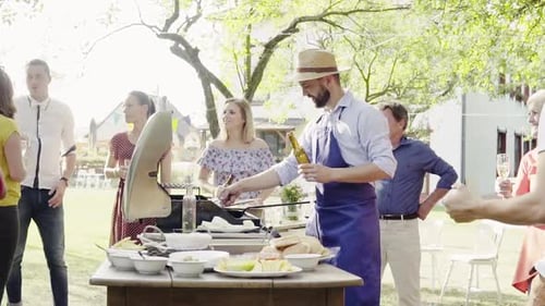 Friends Enjoying Outdoor Barbecue in Summer Sunshine