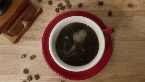 Hot Cup of Coffee with Beans and Grinder