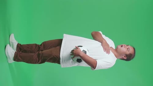 Full Body Of Asian Man With A Ball Singing National Anthem While Cheering Soccer On Green Screen