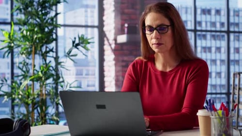 Mature Person Overseeing Business Schedule and Planning Activities at Desk