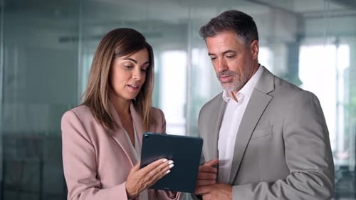 Happy Busy Business Executives Discuss Digital Strategy Using Tablet in Office