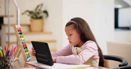 Girl Using Tablet to Study at Home