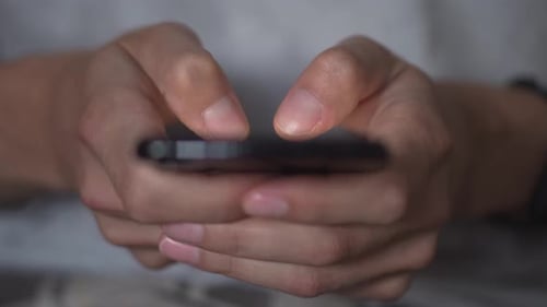 Hands Typing on Mobile Phone, Close Up