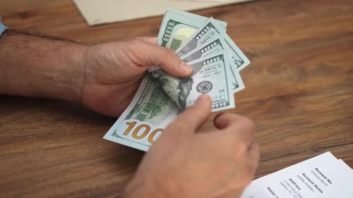 Counting Stack of New One Hundred Dollar Bills