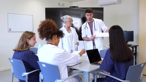 Medical Team Analyzing Patient Data During Hospital Meeting