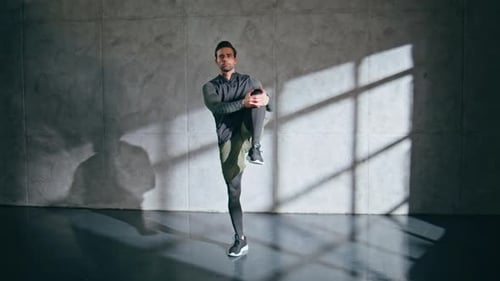 Stretching Sport Man Foot at Loft Gym Serious Motivated Guy Warming Up Body