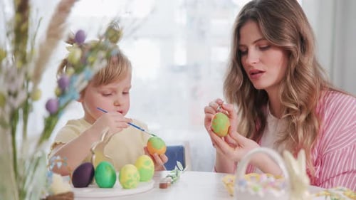 Happy Mother and Child Creating Easter Crafts at Home