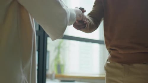Handshake of Multiethnic Man and Woman in Office