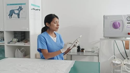 Vet Tech Using Tablet in Examination Room