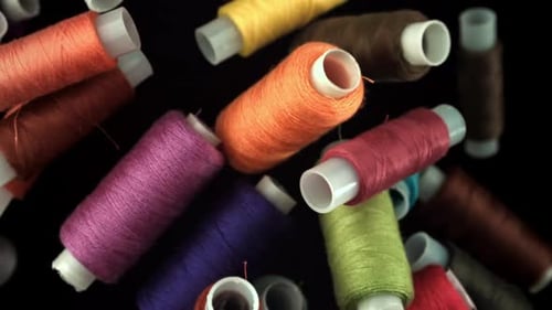 Multicolored Threads Fly on a Black Background Filmed on a Highspeed Camera at 1000 Fps