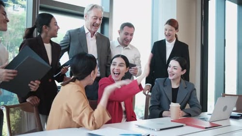 Diverse Corporate Team Celebrating Successful Business Meeting in Modern Office