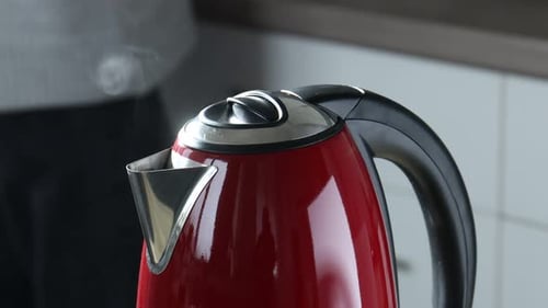 Red Kettle Steaming in Kitchen for Tea