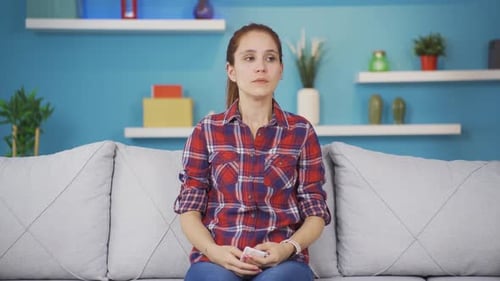 Sick Woman with Flu Blows Nose at Home