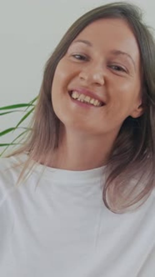 Smiling Woman in White T-Shirt Close-up