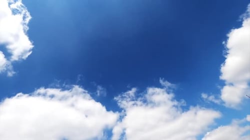 Light white clouds floating quickly in the bright blue skies.