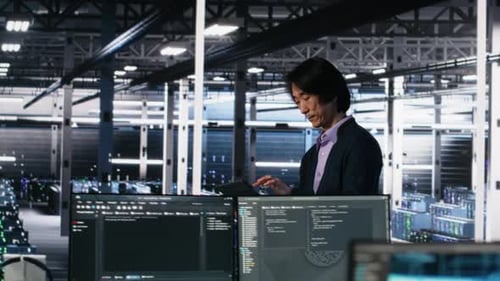 Data Center Manager Supervising Developer Using Device to Monitor Neural Network