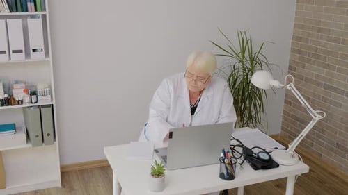 Woman doctor studies online during her lunch break.