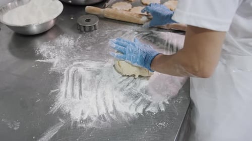 Baker Rolling Dough CloseUp Bakery Production