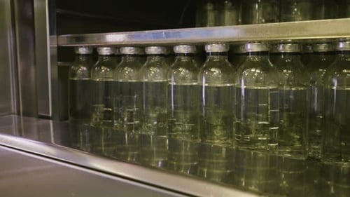 Glass Bottles on Shelf in Metal Case