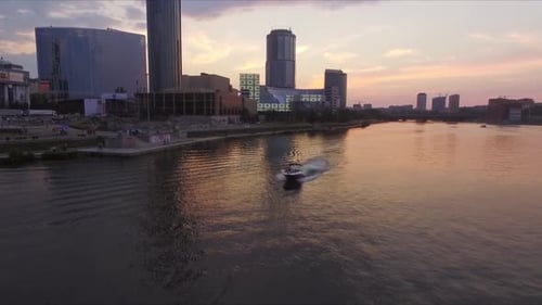 Aerial shot of A boat floats on the river in city against sky during sunset 08