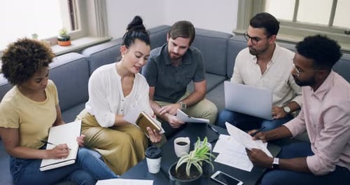 4k video footage of a group of young businesspeople having a meeting in a modern office