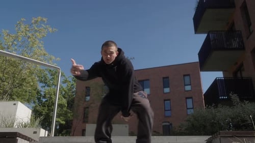 A street dancer performs dynamic freestyle, blending various street dance styles