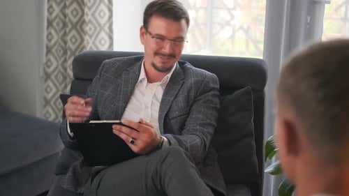 Man in Suit Talking During Therapy Session