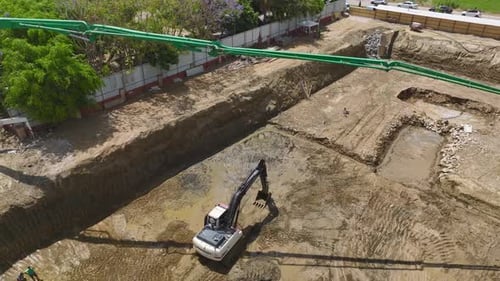 Aerial View Building Foundations First Concrete Pour with Heavy Equipment