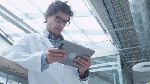 Latin Ethnicity Student of Medical School using Tablet Computer in Hallway