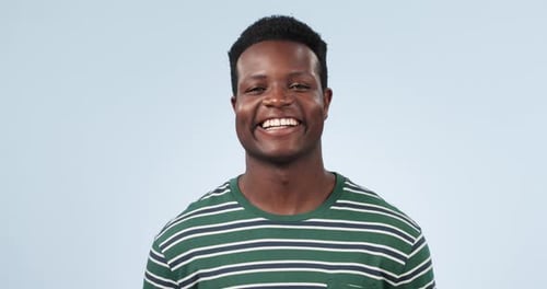 Happy, face and a black man on a studio background while laughing for a joke, meme or expression