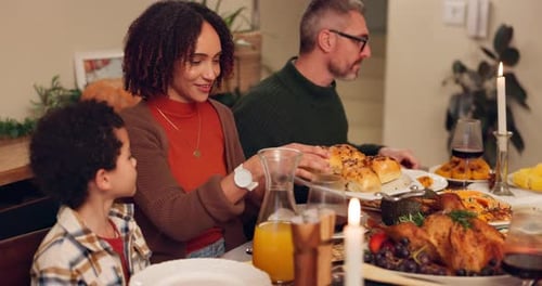 Happy interracial family, dining and food with table for thanksgiving dinner