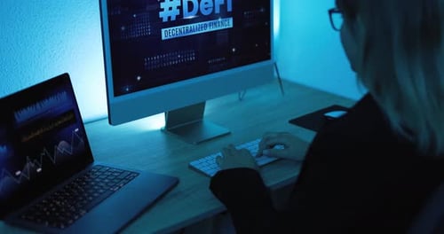 Young Adult Typing at Computer at Night