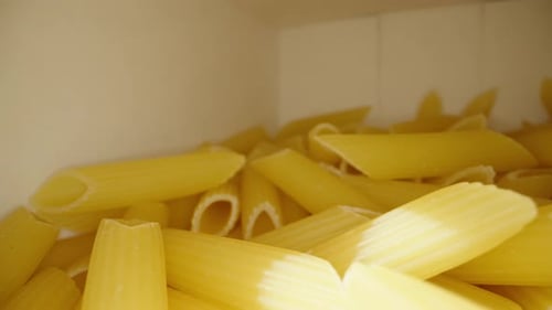 I take a handful of pasta out of the box. Dolly slider extreme close-up.