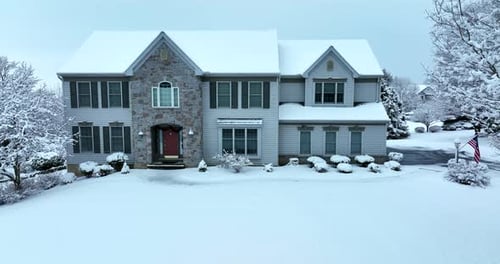 Snow Covered Suburban House in Winter Aerial