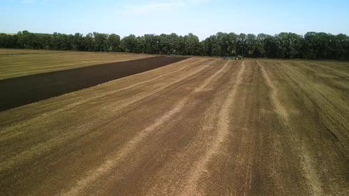 Tractors plowing the field in Ukraine