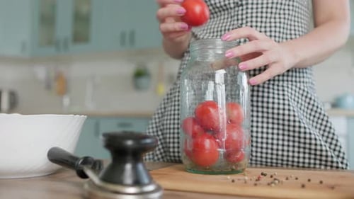 A Brunette Woman Prepares and Cuts Vegetables in the Kitchen