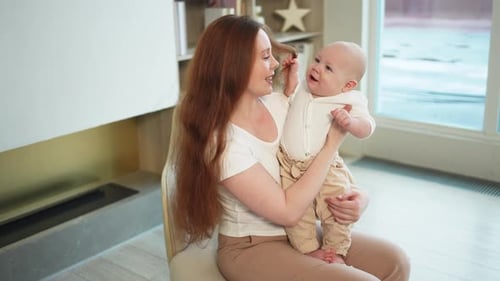 Loving Mother Cradling Baby in Modern Home