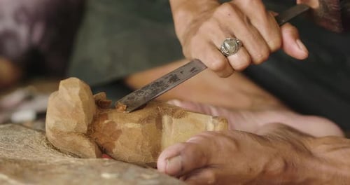 An artisan creates sculptures with chalk to make statues and works of art by hand as the manufactu
