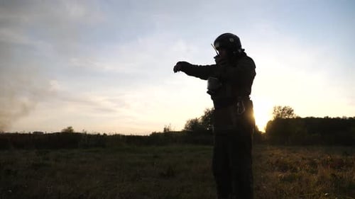 Professional Fireman in Full Equipment Talking on Walkietalkie on Place at Fire Near a Big Red Truck
