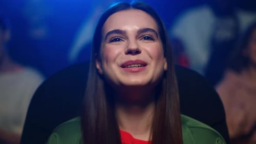 Closeup Young Woman Watching Comedy in Movie House. Portrait of Happy Girl