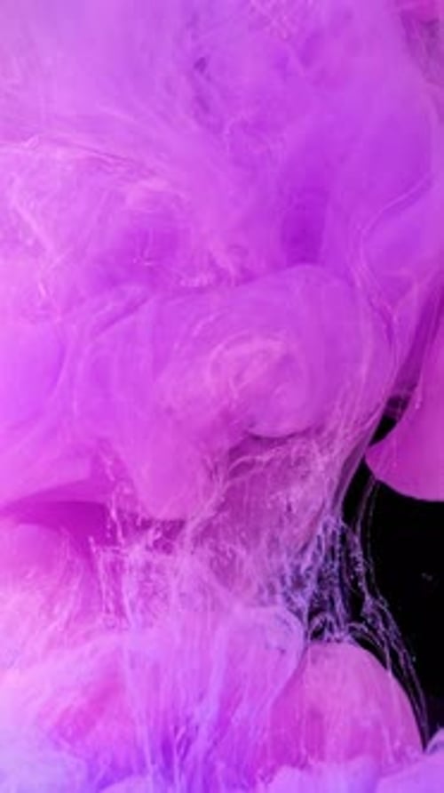 Pink and Blue Ink Slowly Mixing in Water