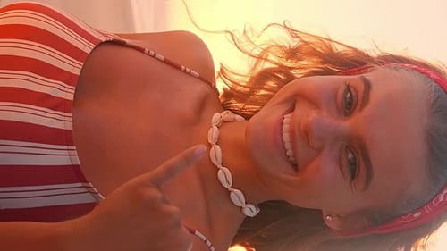Young Happy Caucasian Woman Inviting to Surf Stands on Beach Near Ocean