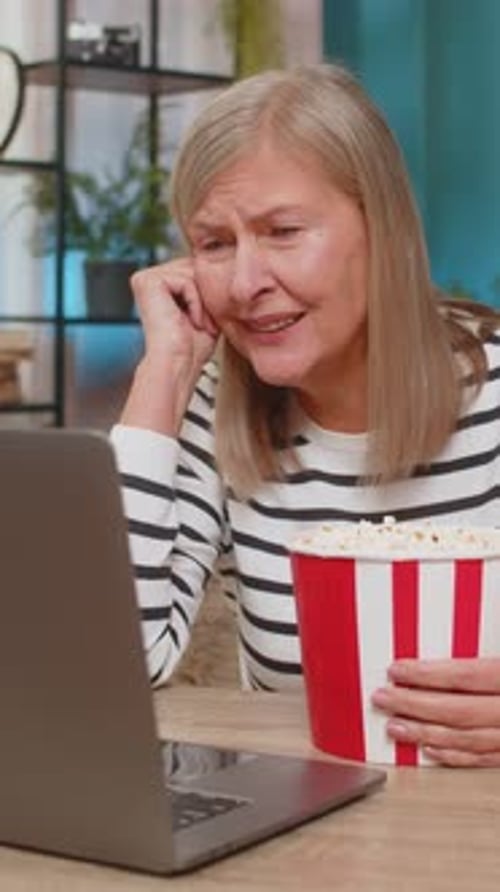 Woman Enjoys Movie with Popcorn at Home