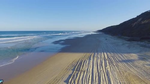 High quality and super smooth tracking shot at golden hour over a broad Queensland beach on Fraser I