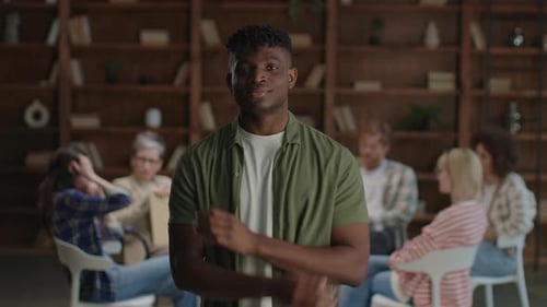 Confident Young Adult Smiling in Group Therapy Session