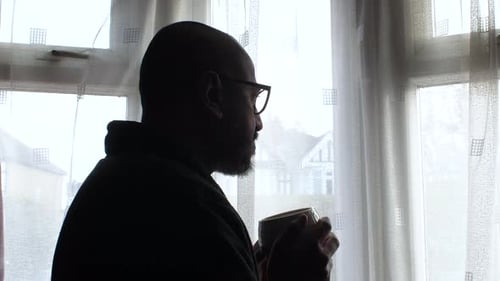 Adult Man Drinking Coffee by Window