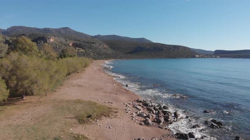 Aerial beautiful beach and water bay in the greek spectacular coast line. Turquoise blue transparent