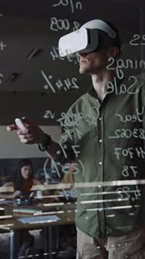 App Developer Using VR Headset with Remote Controller in Office