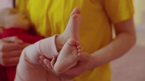 Baby Feet in Adult's Hands