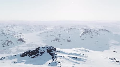 A Snowcovered Mountain Range with Majestic Peaks in the Backdrop